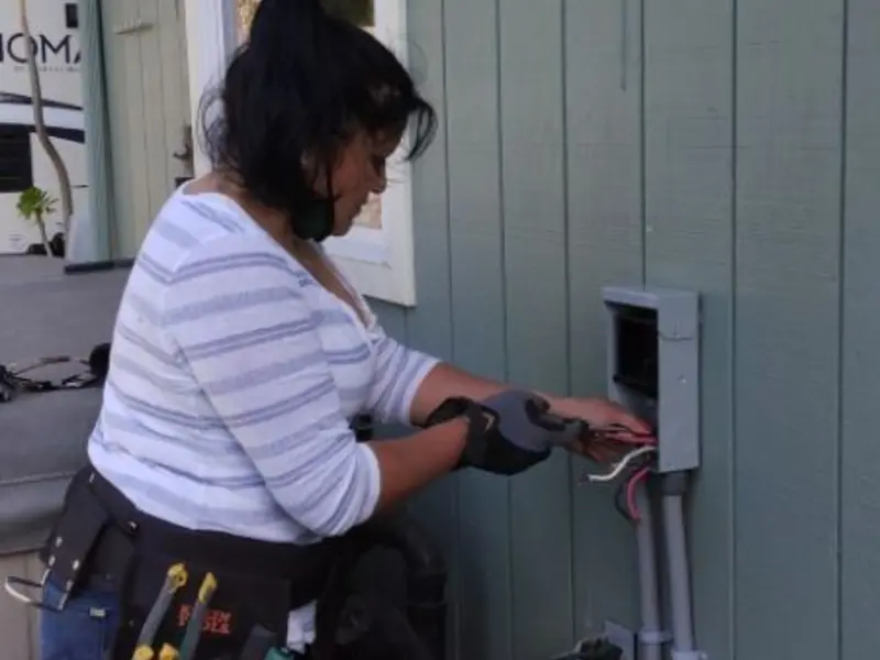 Licensed electrician wiring an exterior subpanel in Alma